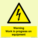 warning-work-in-progress-on-equipmentwith-electrical-hazard-symbol~